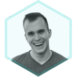 A young man with short hair smiles widely. The image is in black and white and framed by a light blue hexagon, representing a focus on Shift-Left Security in CI/CD practices.