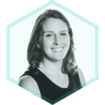 Black and white portrait of a woman with shoulder-length hair, wearing a sleeveless top, smiling at the camera. A hexagonal teal outline frames the image, echoing themes of API Attack Surface Discovery on a light background.